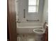 Well-lit bathroom with a white tub, toilet, tiled walls and accessibility grab bars at 2621 N Tacoma Ave, Indianapolis, IN 46218