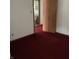 Bedroom view with a doorway leading to a bathroom, plus red carpet flooring at 2621 N Tacoma Ave, Indianapolis, IN 46218