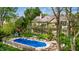 Aerial view of pool and backyard showcasing lush greenery and a charming playhouse at 265 Monticello Dr, Greenwood, IN 46142