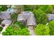 Stunning aerial view of an estate home with inground pool, lush trees and three car garage at 265 Monticello Dr, Greenwood, IN 46142