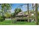 Multi-level deck overlooking landscaped backyard with mature trees and lush green ground cover at 265 Monticello Dr, Greenwood, IN 46142