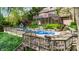 Backyard showcasing pool, deck, lush landscaping and back of home with balcony at 265 Monticello Dr, Greenwood, IN 46142