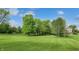 Spacious backyard with mature trees and well-maintained lawn, ideal for outdoor activities and relaxation at 265 Monticello Dr, Greenwood, IN 46142