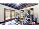 Finished basement featuring workout space, mirrored wall, gym equipment, and access to outside at 265 Monticello Dr, Greenwood, IN 46142