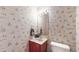 Powder room with decorative wallpaper, sink, vanity and mirror, with toilet at 265 Monticello Dr, Greenwood, IN 46142