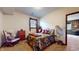 Cozy bedroom with floral bedding, side table with lamp, and window at 265 Monticello Dr, Greenwood, IN 46142