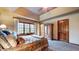 Bedroom with large bright window, tray ceiling and hardwood floors at 265 Monticello Dr, Greenwood, IN 46142