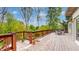 Spacious wooden deck with railing, potted plants, outdoor seating and mature trees at 265 Monticello Dr, Greenwood, IN 46142