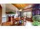 Elegant dining room with hardwood floors, brick accent wall, wood ceiling and bright window at 265 Monticello Dr, Greenwood, IN 46142