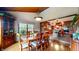 Warm dining room with a wooden table, chairs, and large windows with bright light at 265 Monticello Dr, Greenwood, IN 46142