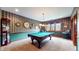 This game room features an elegant pool table with overhead lighting, window, and decorative walls at 265 Monticello Dr, Greenwood, IN 46142