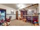 Basement playroom with a custom loft, shelves filled with stuffed animals, and colorful wallpaper border at 265 Monticello Dr, Greenwood, IN 46142