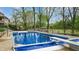 Pool with cover and diving board, surrounded by patio and mature trees at 265 Monticello Dr, Greenwood, IN 46142