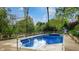 Refreshing in-ground pool with lounge area, steel ladder and mature trees at 265 Monticello Dr, Greenwood, IN 46142