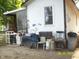 View of the home's rear exterior, showing access, a window, and an enclosed porch at 3049 S Rybolt Ave, Indianapolis, IN 46241