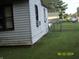 Side view of home with a spacious, grassy backyard, with a chain link fence at 3057 S Rybolt Ave, Indianapolis, IN 46241