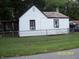 Side view of a white home with black trim, windows and a chain link fence at 3057 S Rybolt Ave, Indianapolis, IN 46241