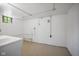 Clean basement with painted concrete walls and floor, featuring essential utility connections and a small window at 311 Duffey St, Plainfield, IN 46168