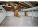 Spacious unfinished basement with open ceiling and painted walls, providing ample room for customization at 311 Duffey St, Plainfield, IN 46168