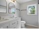Bathroom features double sinks, modern fixtures, new lighting, and a window providing ample natural light at 311 Duffey St, Plainfield, IN 46168
