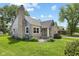 Lovely home featuring stone and siding, a well-manicured lawn, and mature trees at 311 Duffey St, Plainfield, IN 46168