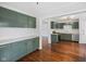 Bright, updated kitchen with sage cabinets and stainless steel appliances, with an open layout concept at 311 Duffey St, Plainfield, IN 46168