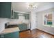 Updated kitchen featuring sleek, sage green cabinetry, stainless steel appliances, and a stylish backsplash at 311 Duffey St, Plainfield, IN 46168