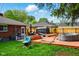Backyard featuring wooden deck, above ground pool, black grill, and lush green grass at 349 Clark Ave, Beech Grove, IN 46107