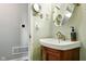 Bathroom featuring a modern sink vanity with bronze fixtures and a unique oval mirror at 349 Clark Ave, Beech Grove, IN 46107