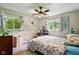 Tranquil bedroom with natural light, floral accents, and a cozy bed at 349 Clark Ave, Beech Grove, IN 46107