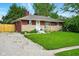 Inviting single-story home with a well-kept lawn and a classic brick and stone facade at 349 Clark Ave, Beech Grove, IN 46107