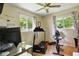 Home office featuring a treadmill, exercise bike, and a desk next to sunlit windows at 349 Clark Ave, Beech Grove, IN 46107