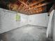 Unfinished basement with window and exposed ceiling at 3516 Janet Dr, Indianapolis, IN 46218