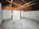 Unfinished basement shows white door and overhead beams at 3516 Janet Dr, Indianapolis, IN 46218