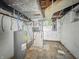 Unfinished basement featuring a water heater and open ceiling at 3516 Janet Dr, Indianapolis, IN 46218