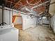 Unfinished basement shows white walls, exposed ceilings, and laundry hookups at 3516 Janet Dr, Indianapolis, IN 46218