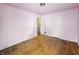 An empty bedroom features hardwood floors, base molding, and a door to a hallway at 3516 Janet Dr, Indianapolis, IN 46218