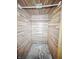 Inside closet with wood paneled walls and open ceiling at 3516 Janet Dr, Indianapolis, IN 46218