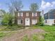 Two-story brick home featuring symmetrical design, white-trimmed windows, and a classic front door at 3516 Janet Dr, Indianapolis, IN 46218