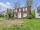 Classic brick two-story home, showcasing symmetrical design, white-trimmed windows, and a front entrance at 3516 Janet Dr, Indianapolis, IN 46218