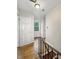 Hallway boasts natural light from window, wooden floor and staircase, and a white door with number at 3516 Janet Dr, Indianapolis, IN 46218
