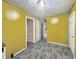 An empty kitchen features yellow walls and gray wood-look vinyl flooring at 3516 Janet Dr, Indianapolis, IN 46218