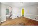An empty living room features hardwood floors, base molding, and access to the stairway at 3516 Janet Dr, Indianapolis, IN 46218