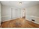 An empty living room features hardwood floors, base molding, and one window at 3516 Janet Dr, Indianapolis, IN 46218