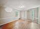 An empty living room features hardwood floors and two windows at 3516 Janet Dr, Indianapolis, IN 46218