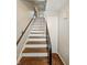 A stairway to the upper level features hardwood steps with metal handrails at 3516 Janet Dr, Indianapolis, IN 46218
