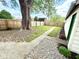 This backyard has a concrete walkway through the grass leading to a tall tree at 417 S Oakland Ave, Indianapolis, IN 46201