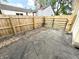 Backyard view with a new wooden fence and gate on an asphalt driveway at 417 S Oakland Ave, Indianapolis, IN 46201