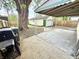 View of the backyard featuring a detached garage, driveway, and mature tree at 417 S Oakland Ave, Indianapolis, IN 46201