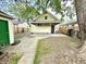 The backyard has a sidewalk leading to the home and detached garage at 417 S Oakland Ave, Indianapolis, IN 46201